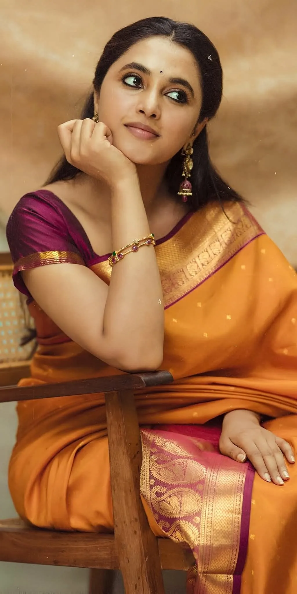 Priyanka Arul Mohan in Thoughtful Pose in Orange Saree HD