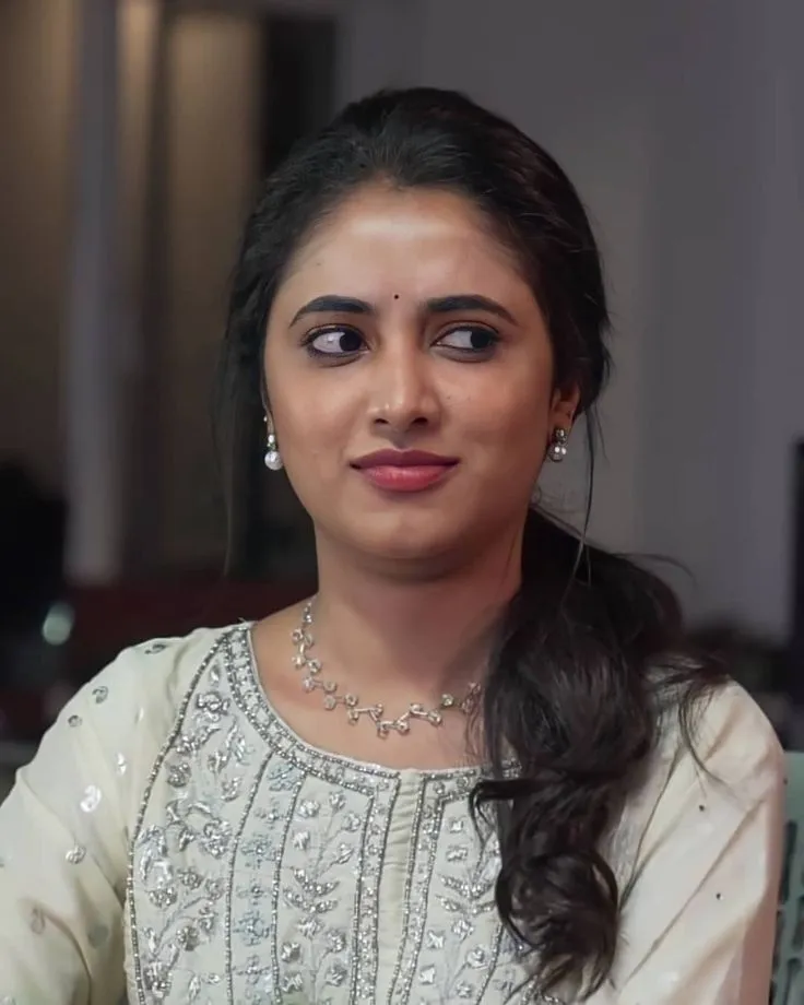Priyanka Arul Mohan in white dress with a gentle smile