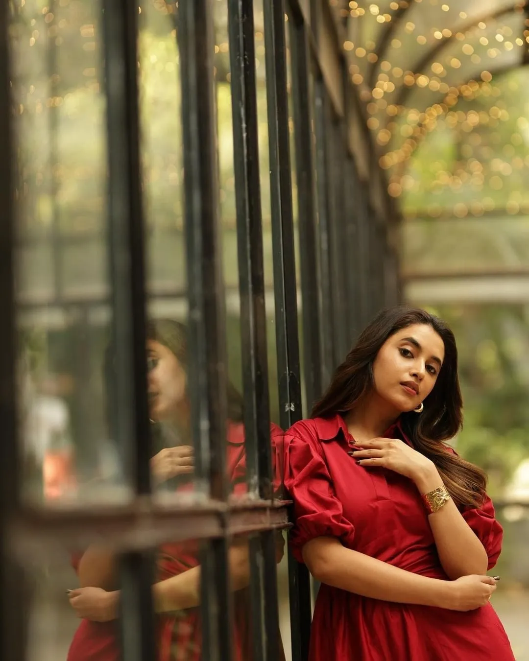 Priyanka Arul Mohan Leaning on Window in Elegant Red Dress