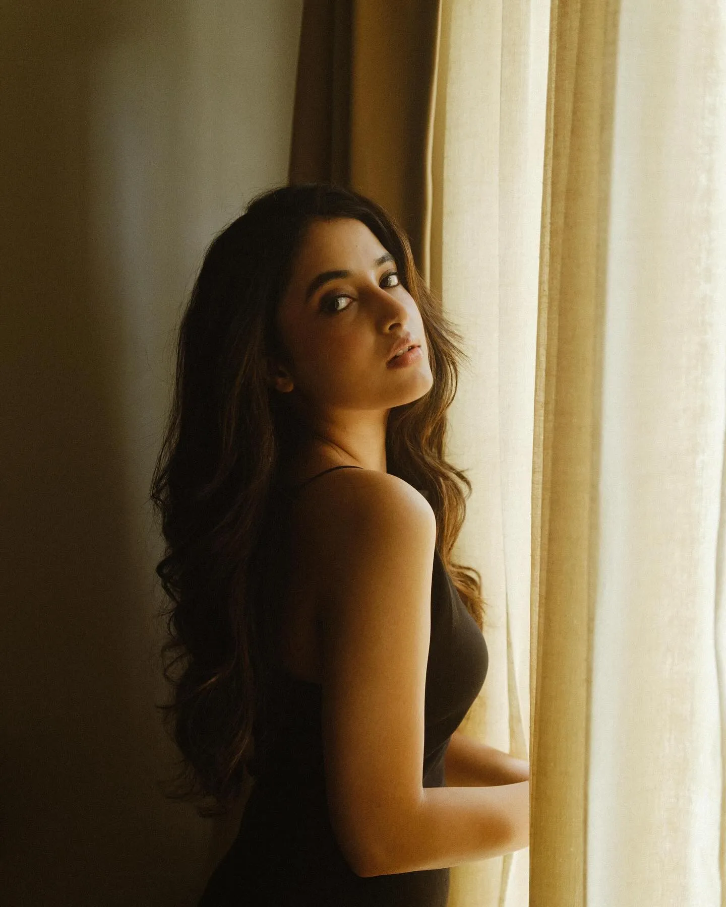 Priyanka Arul Mohan posing near Curtain in Natural Light