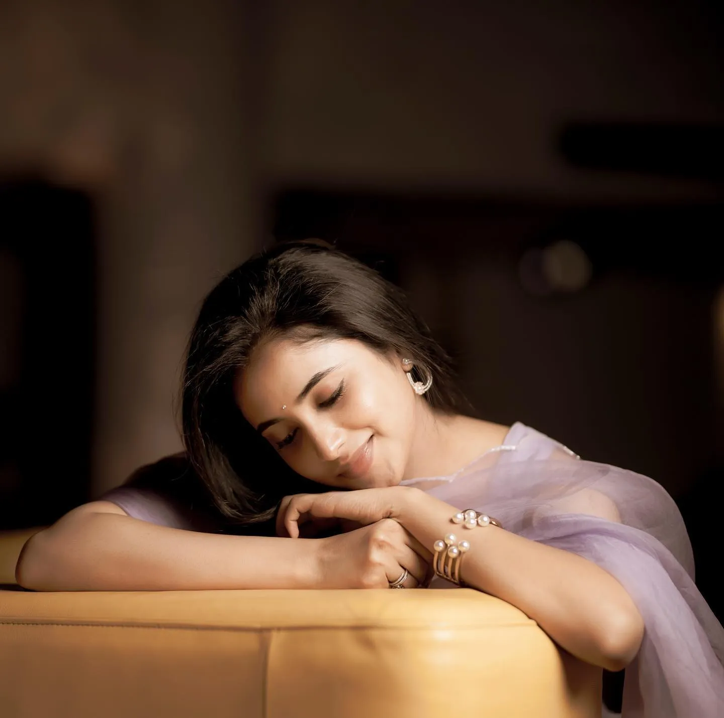 Priyanka Arul Mohan Relaxed Pose Resting in Warm couch image