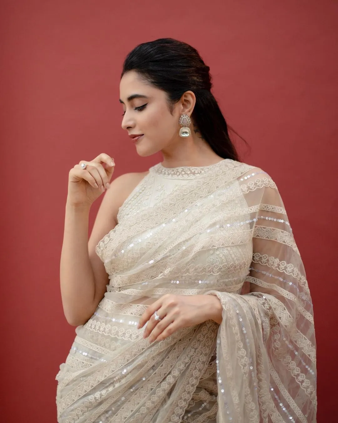Priyanka Arul Mohan serene in cream saree thoughtful pose