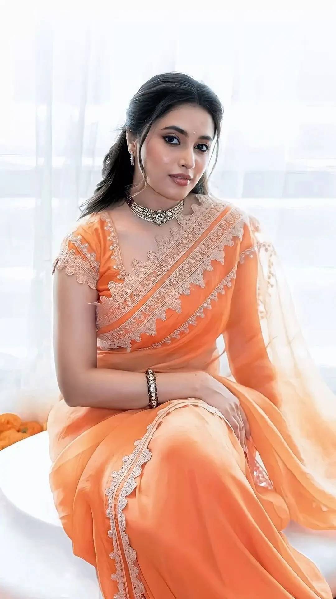 Priyanka Arul Mohan Sitting Gracefully in Orange Saree image