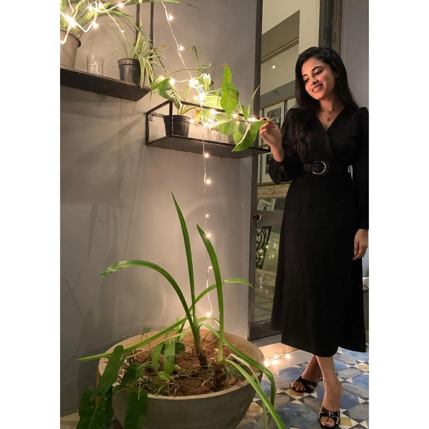 Priyanka Arul Mohan Smiling by Indoor Plants in Black Dress