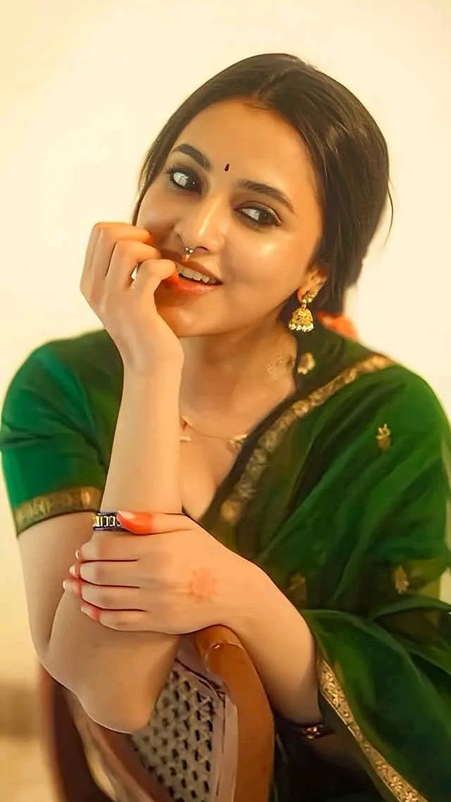 Priyanka Arul Mohan smiling gently in green traditional wear
