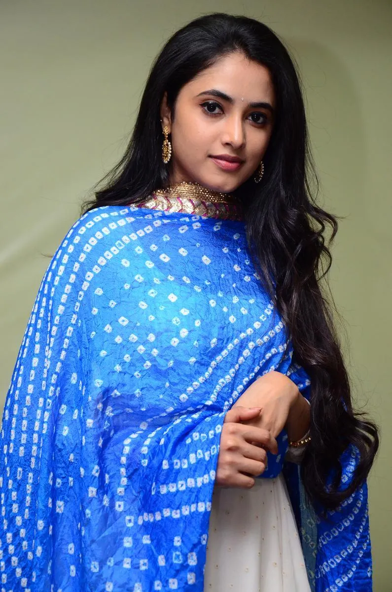 Priyanka Arul Mohan smiling in bright blue traditional look