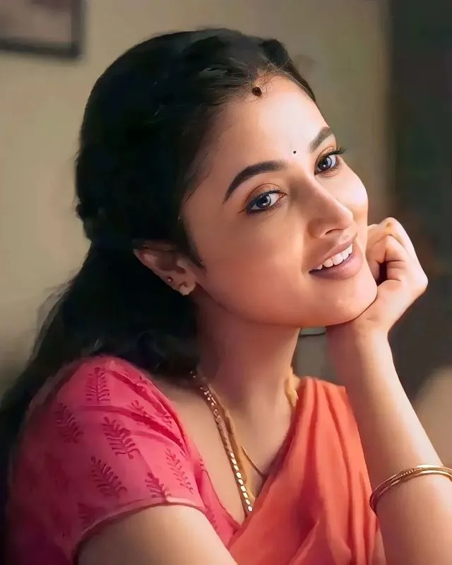 Priyanka Arul Mohan smiling in orange traditional attire