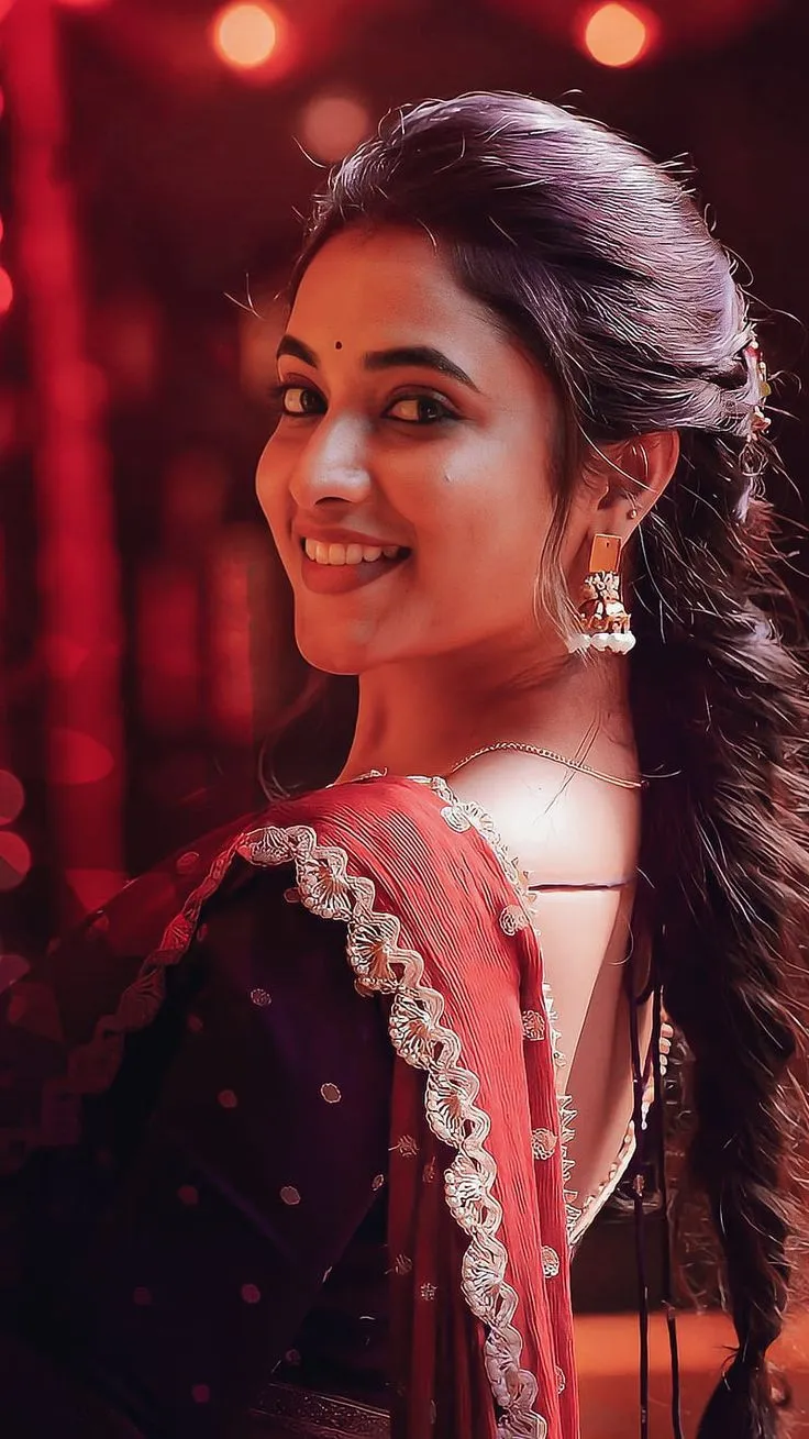 Priyanka Arul Mohan smiling in red and black ethnic outfit
