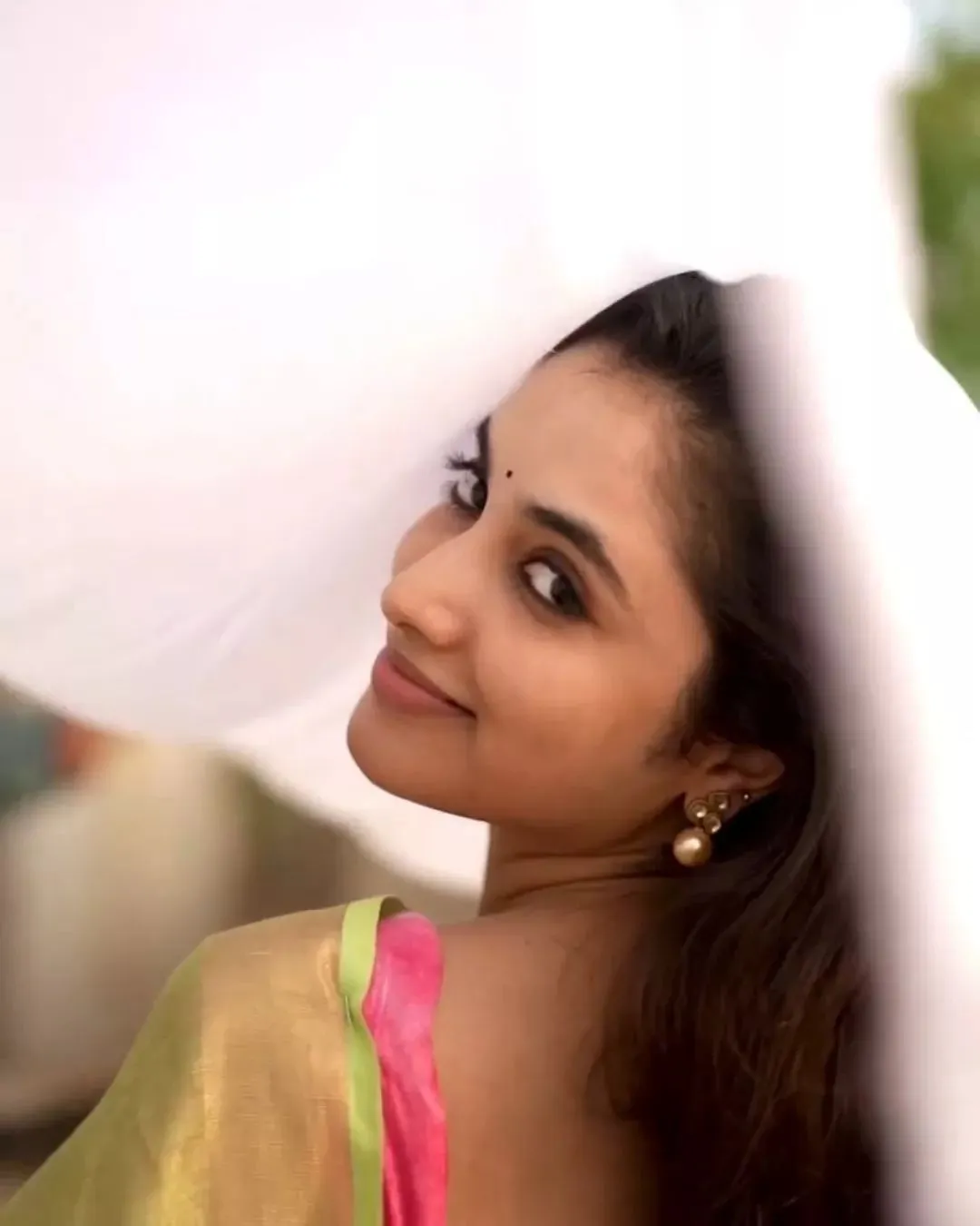 Priyanka Arul Mohan soft expression under pink fabric