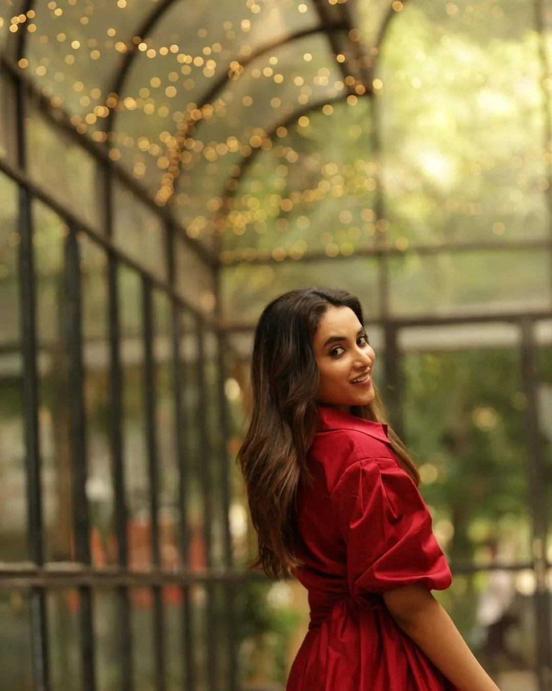 Priyanka Arul Mohan Standing gracefully in red outfit image