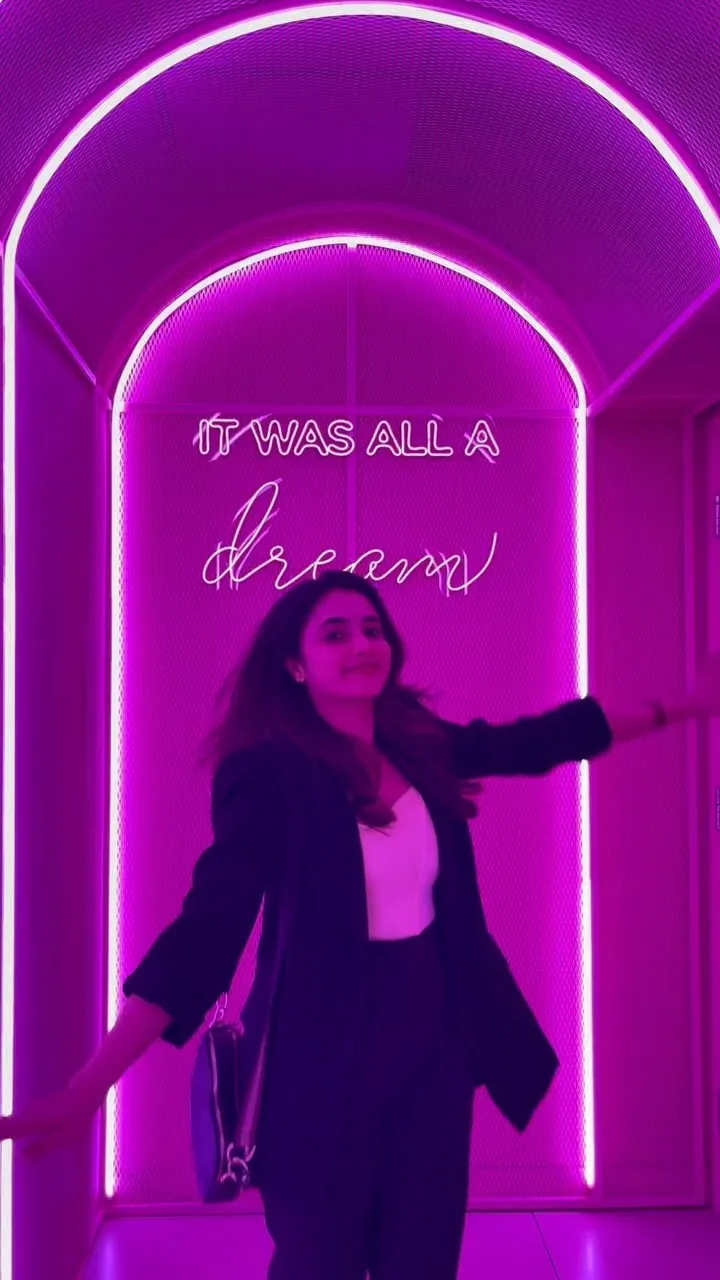 Priyanka Arul Mohan under neon light in stylish black wear