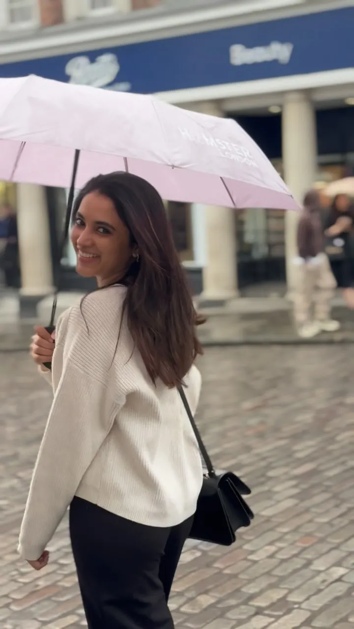 Priyanka Arul Mohan Walking Gracefully with Umbrella image