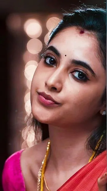 Priyanka Arul Mohan with soft expression in pink outfit