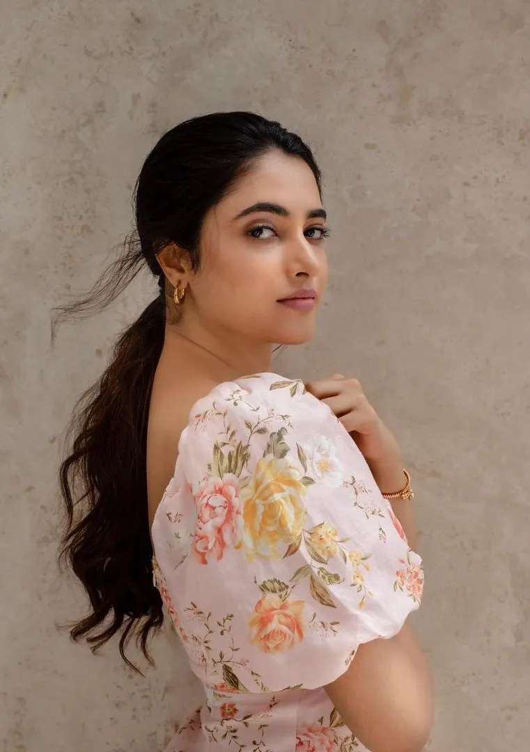 Priyanka in a floral top looking calmly to the side image