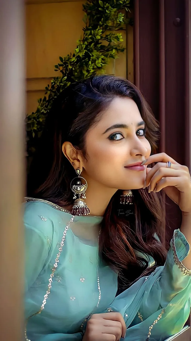 Priyanka in Aqua dress with a thoughtful expression image