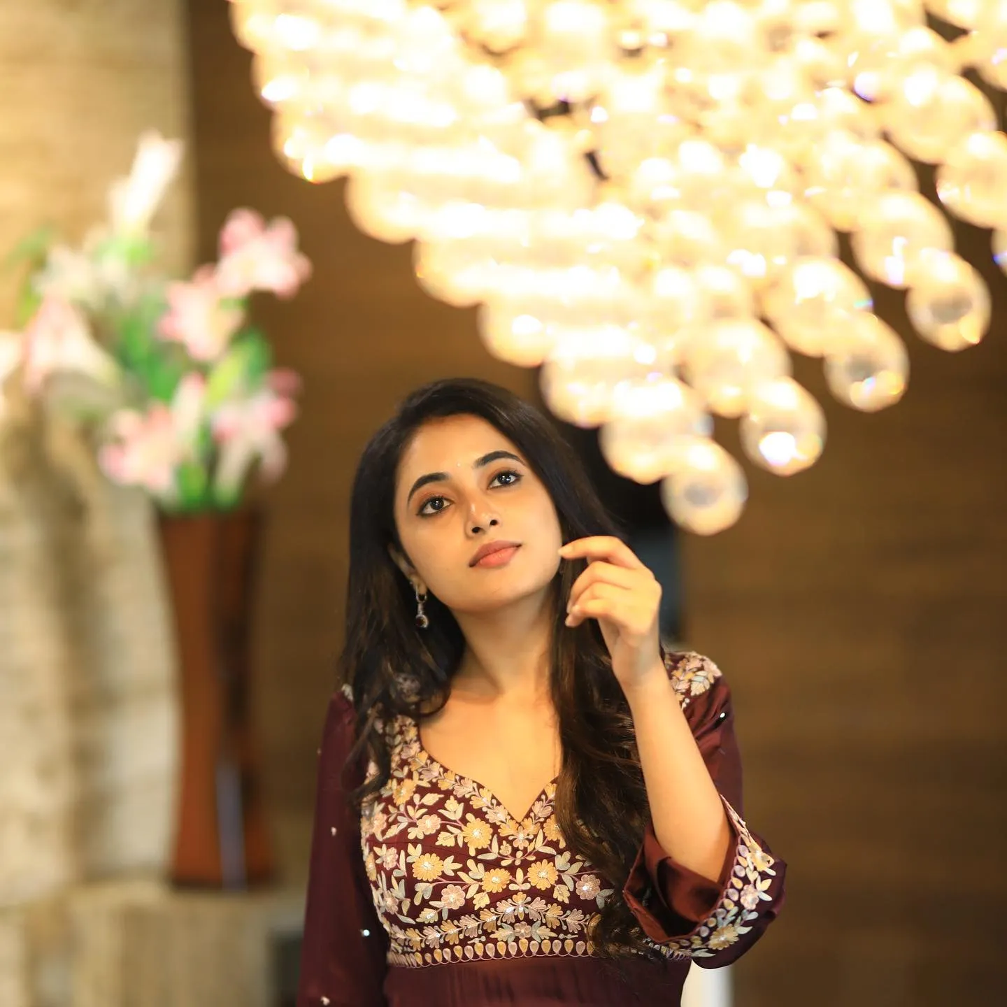 Priyanka in elegant Outfit under warm chandelier light image