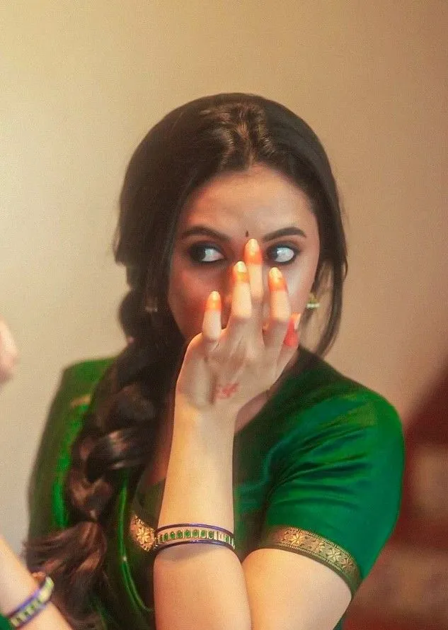 Priyanka in green dress with hands near her face Wallpaper