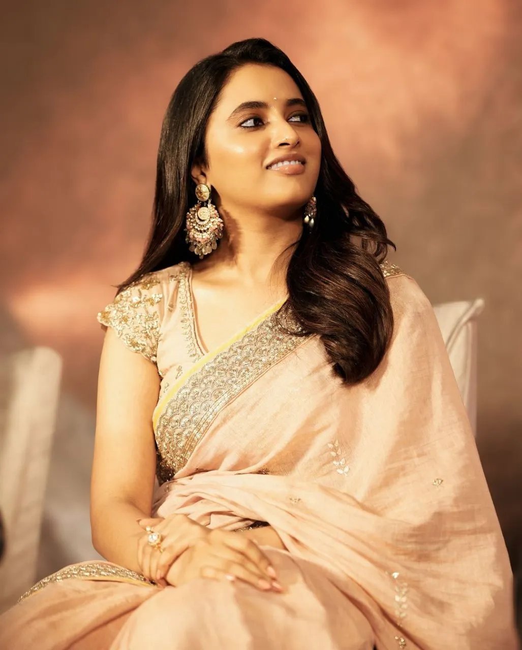 Priyanka in light saree sitting with calm and grace image