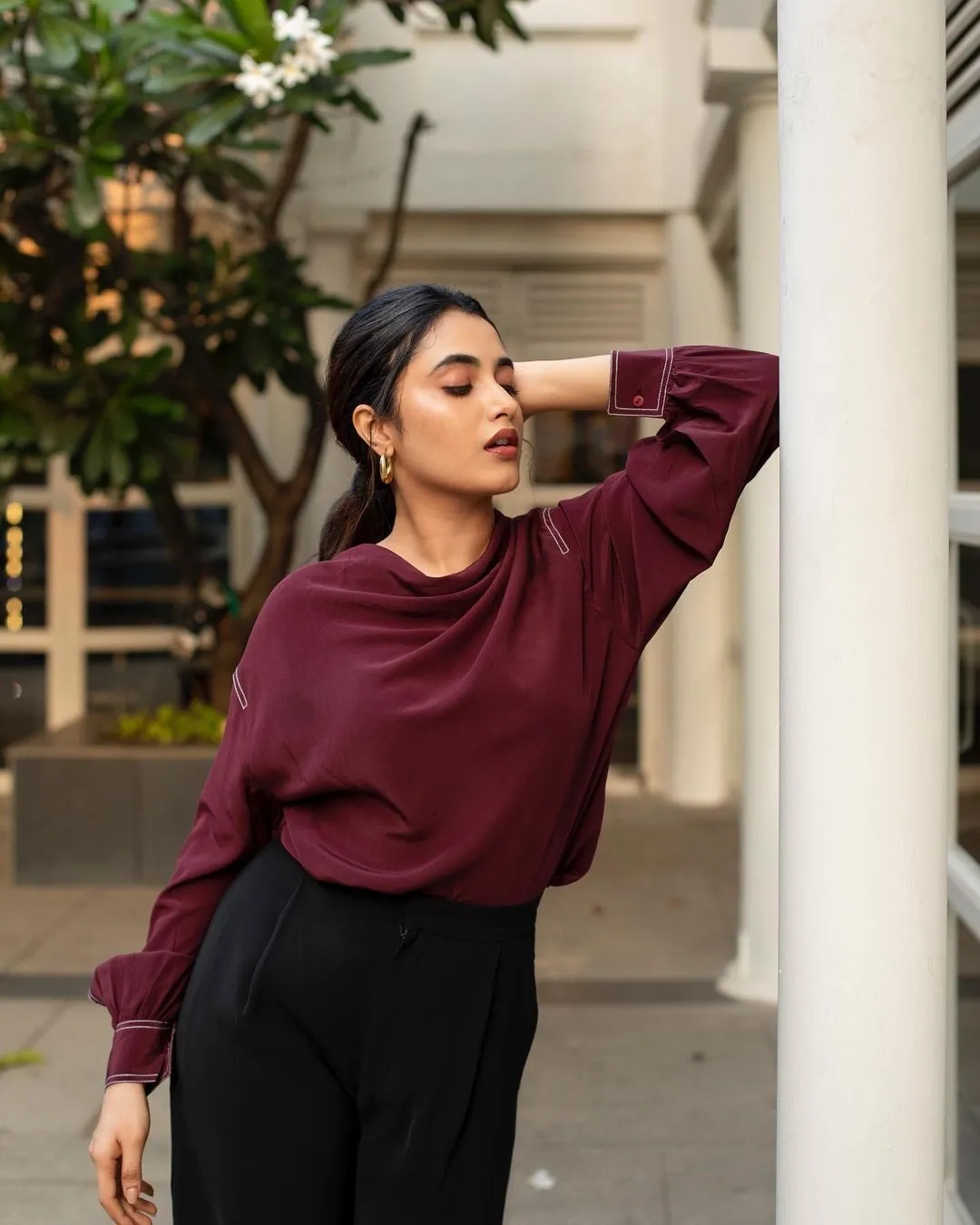Priyanka in maroon crop top and black pants walking image
