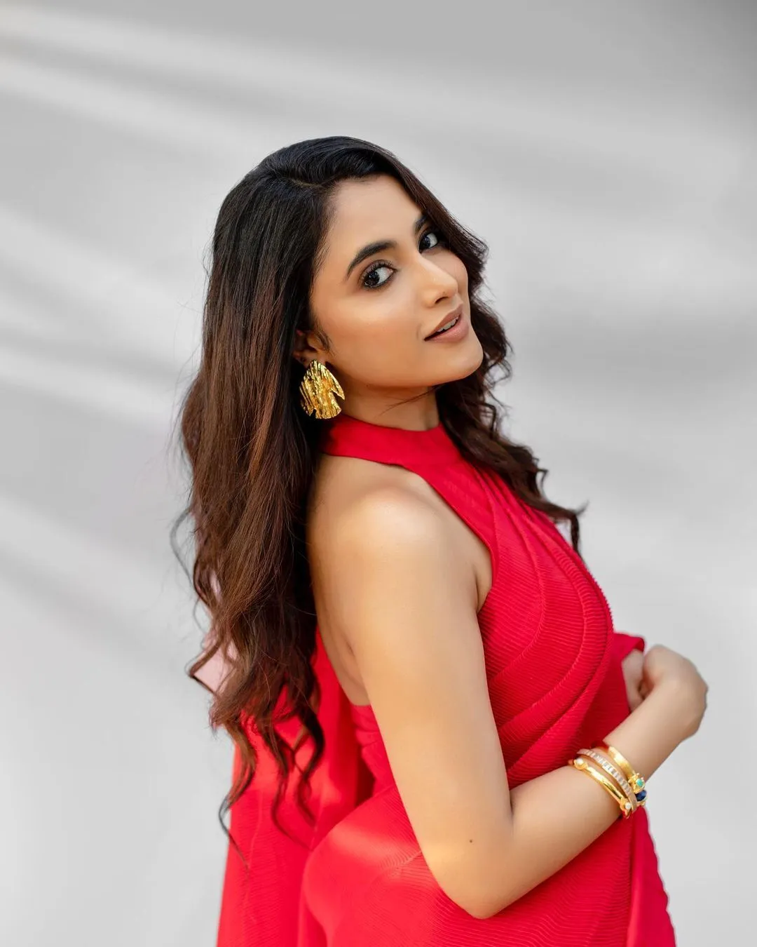 Priyanka in red dress posing against light background image