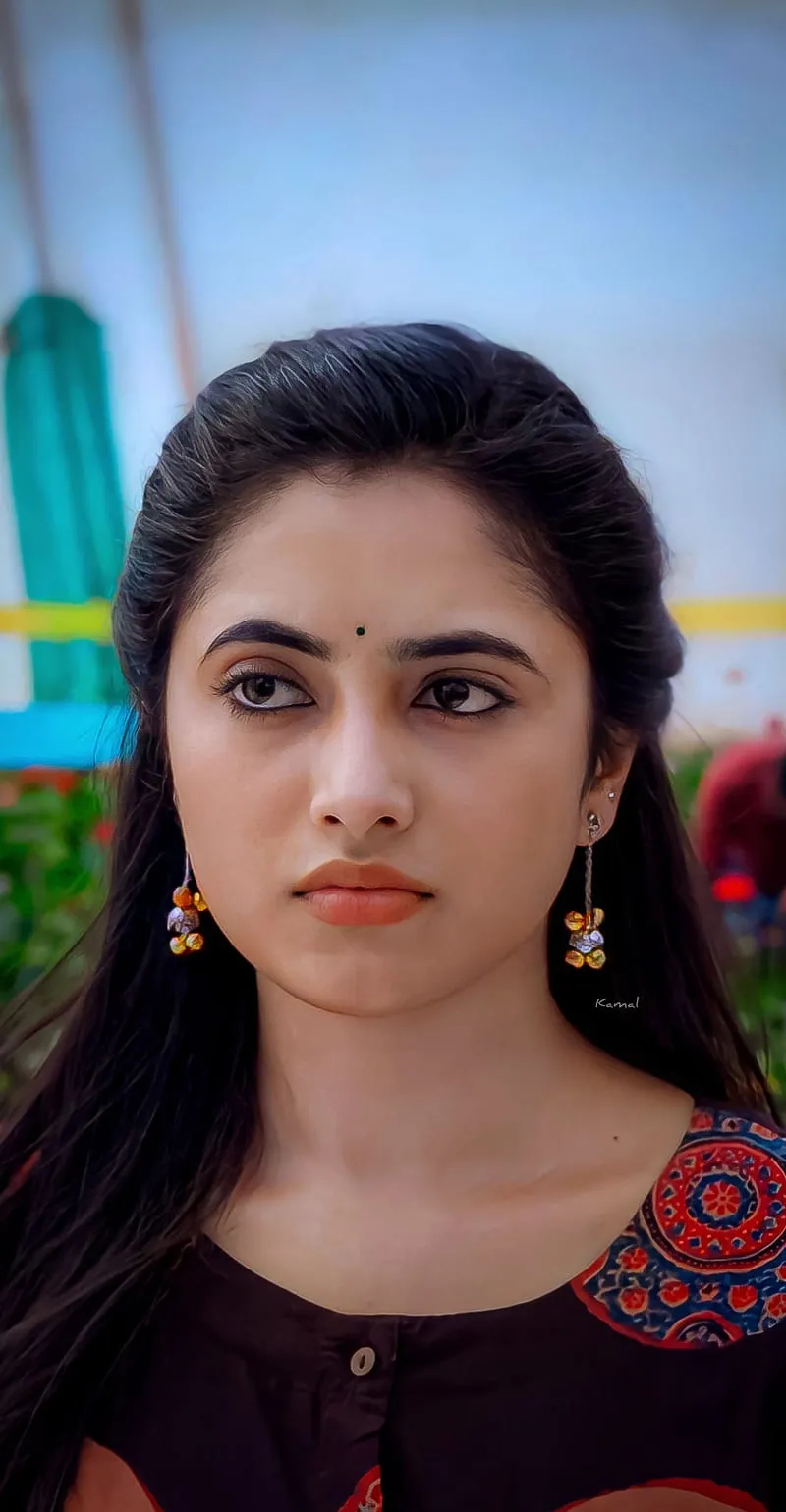 Priyanka in serious look wearing maroon top outdoors