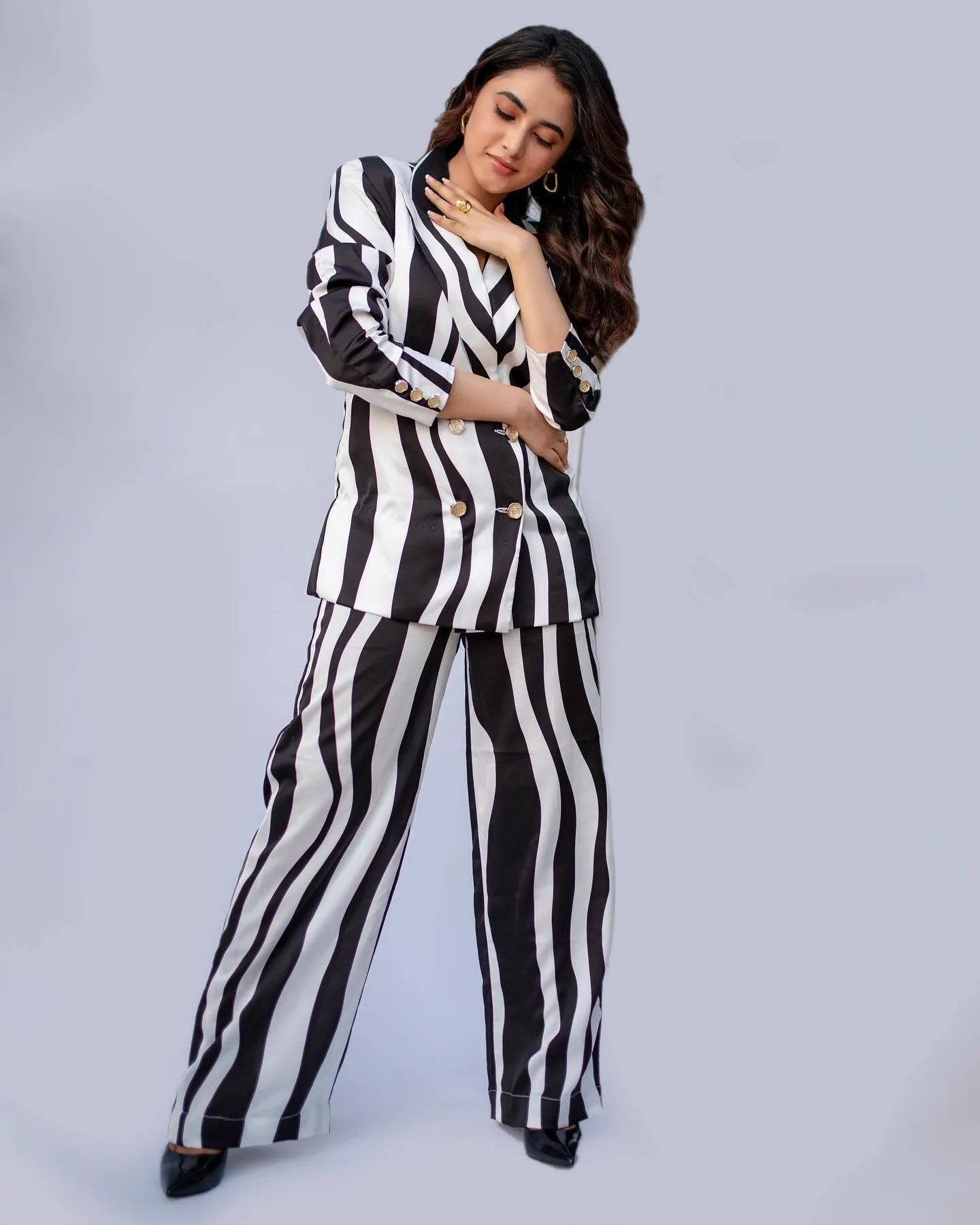 Priyanka in stylish black and white striped pantsuit pose