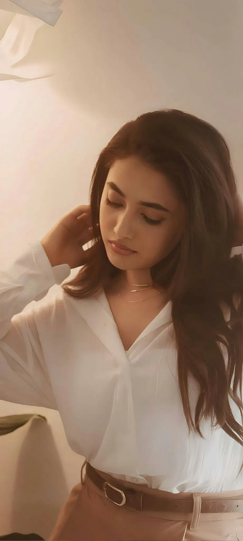 Priyanka in white shirt looking down indoors Wallpaper