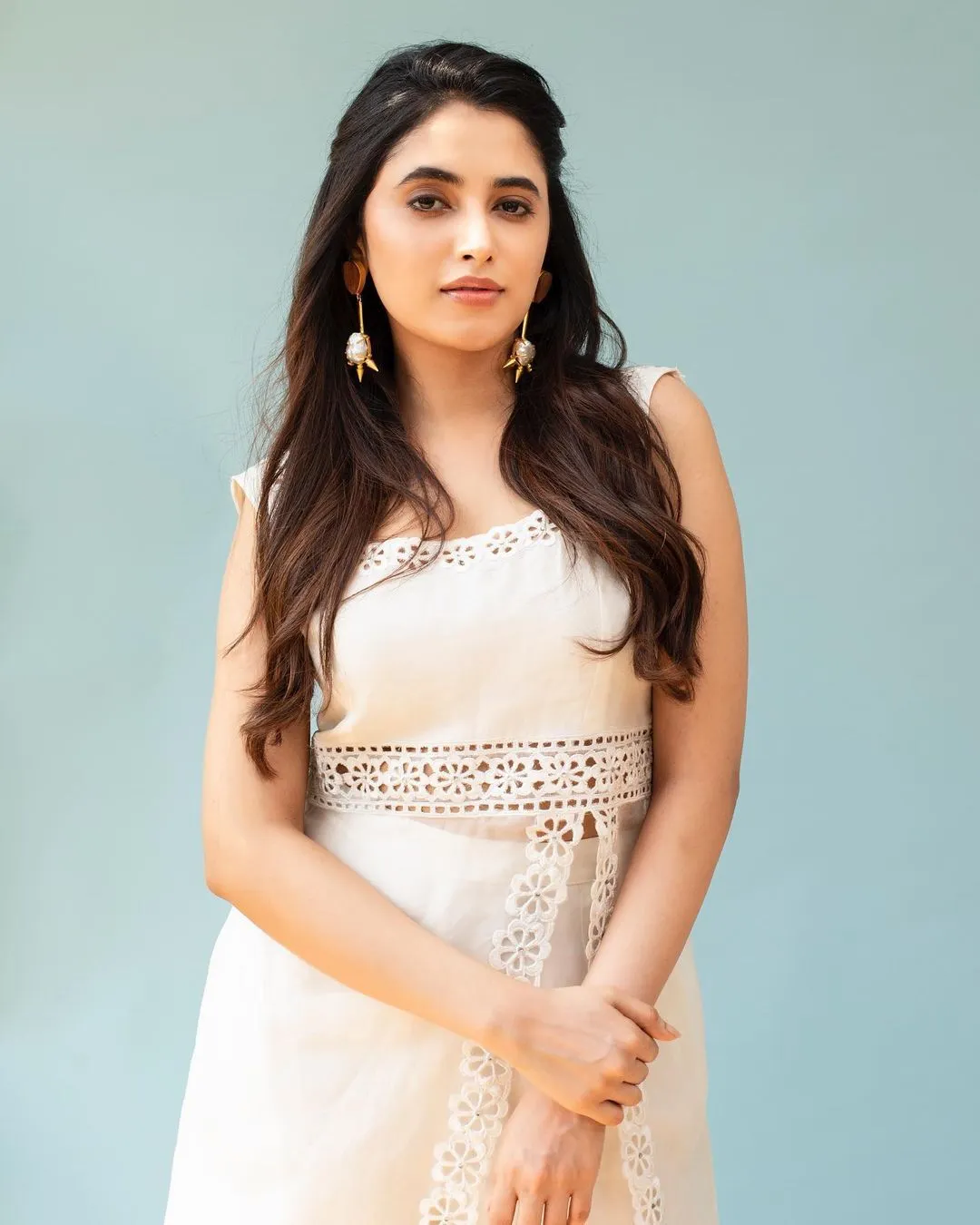 Priyanka in white sleeveless outfit looking composed image