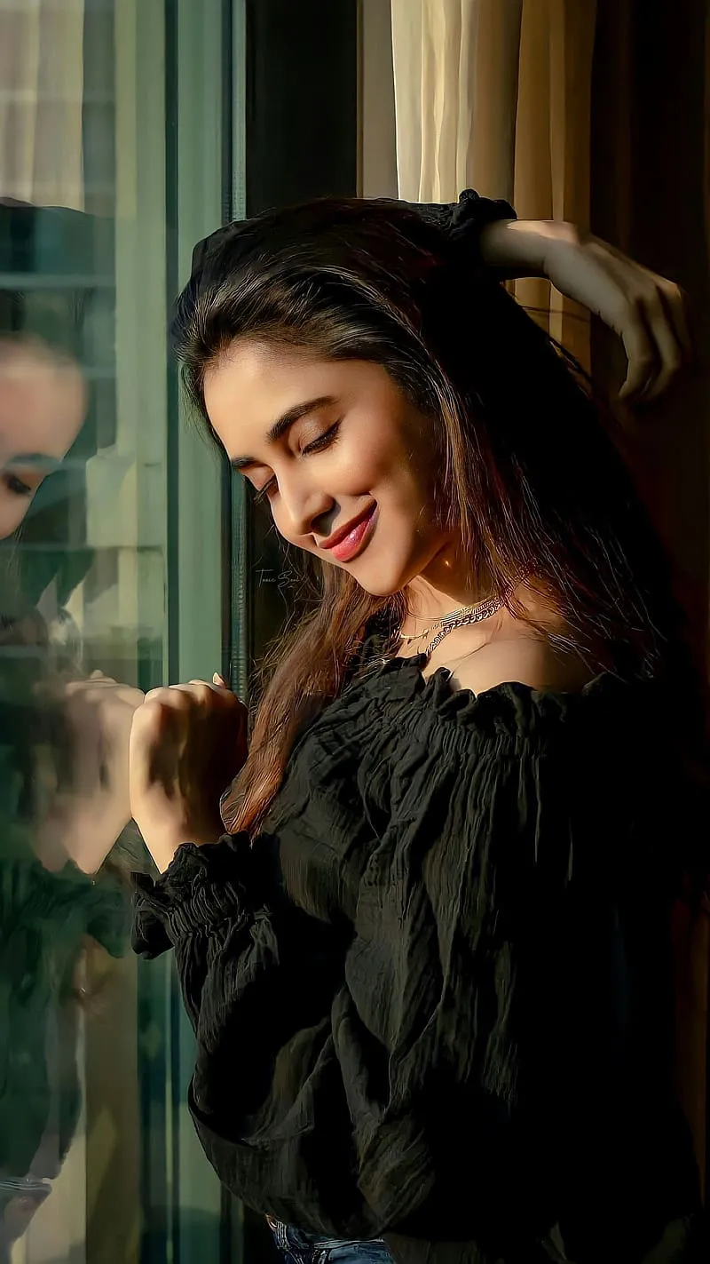 Priyanka leaning on Window in black dress with soft lighting