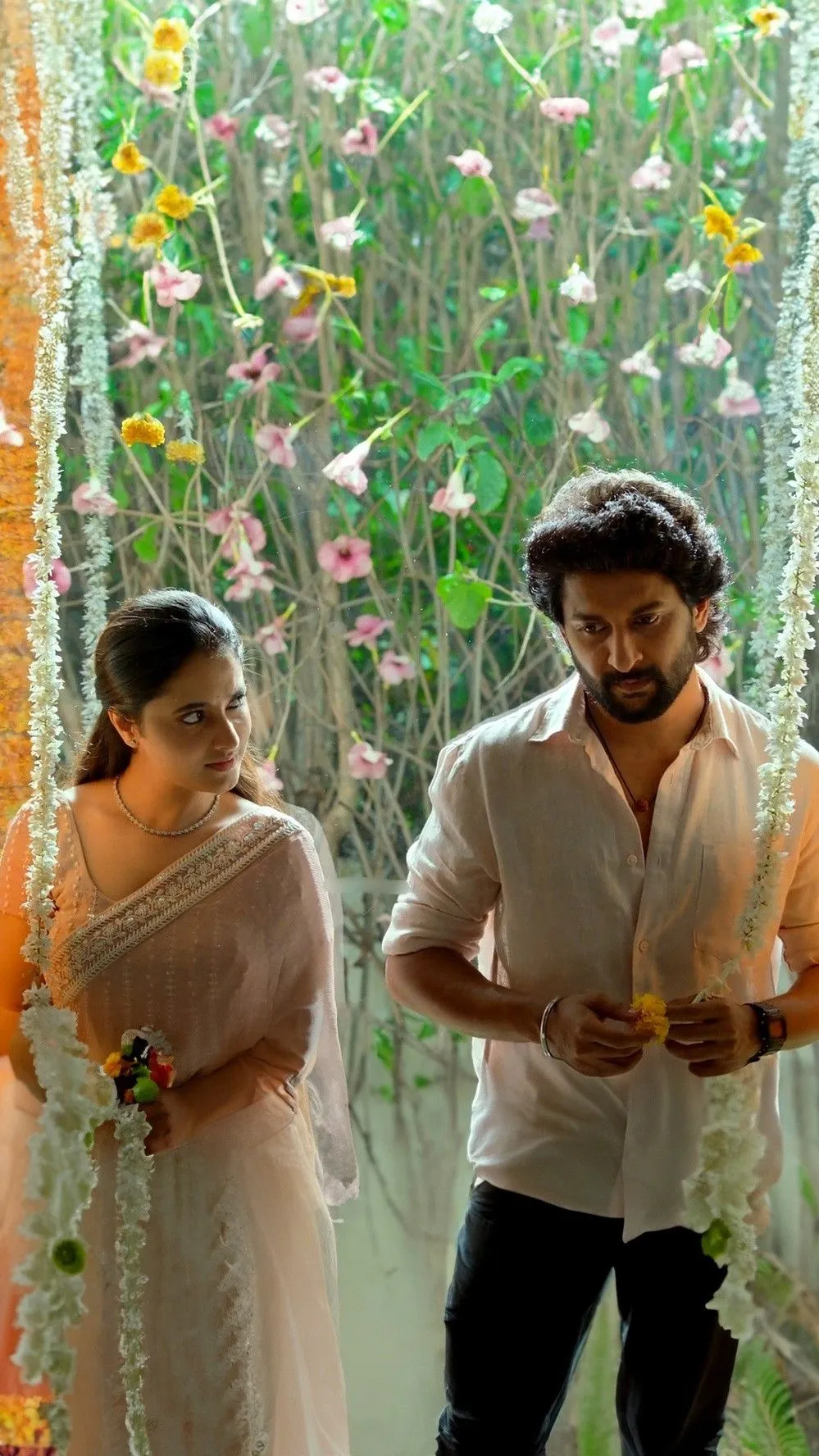 Priyanka Mohan And Nani Standing Near the Floral Background