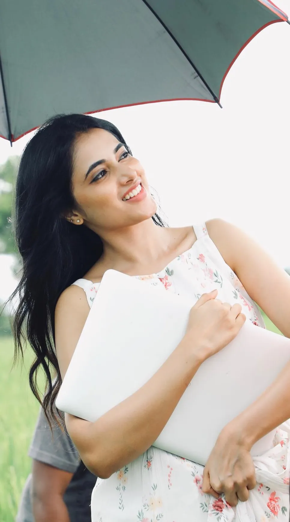 Priyanka Mohan Holding a Laptop Standing Under the Umbrella