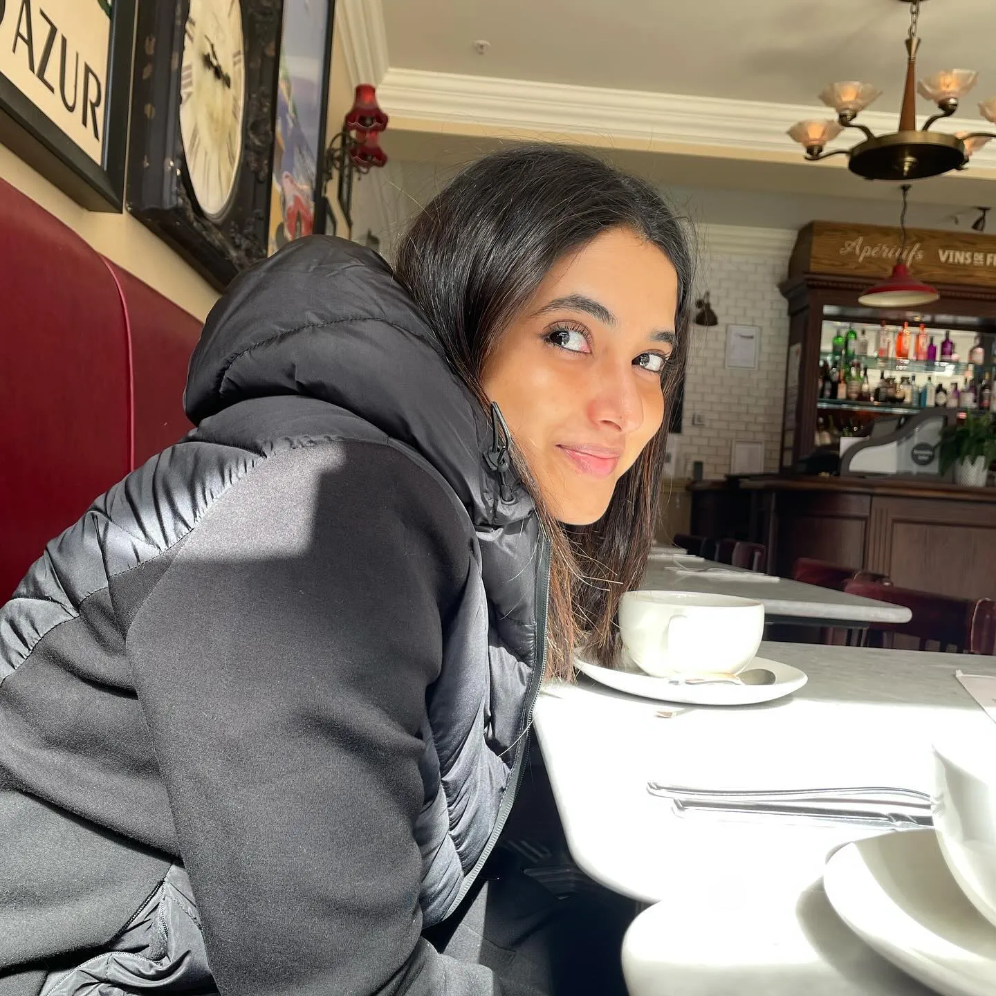 Priyanka Mohan in a Black Dress Sitting in the Coffee Shop
