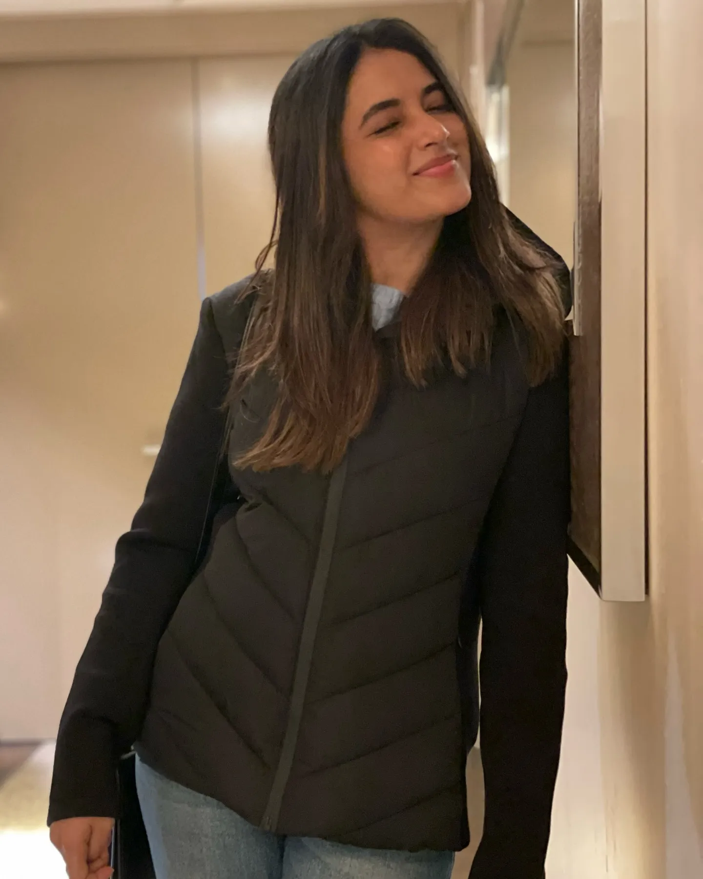 Priyanka Mohan in a Black Outfit Leaning on the Wall Image
