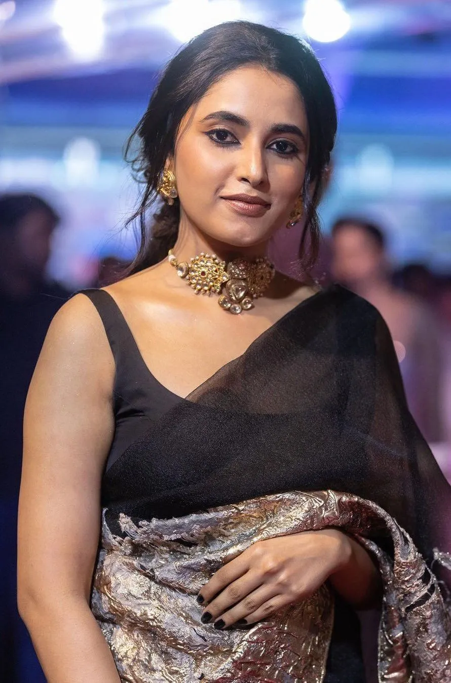 Priyanka Mohan in a Black Saree Standing in a Function Image