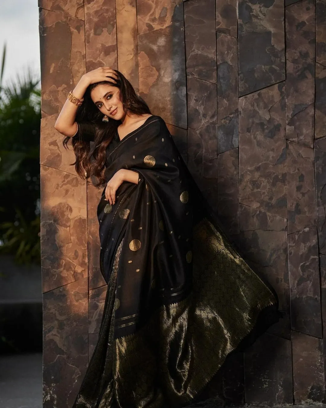 Priyanka Mohan in a Black Saree Standing Near the Wall