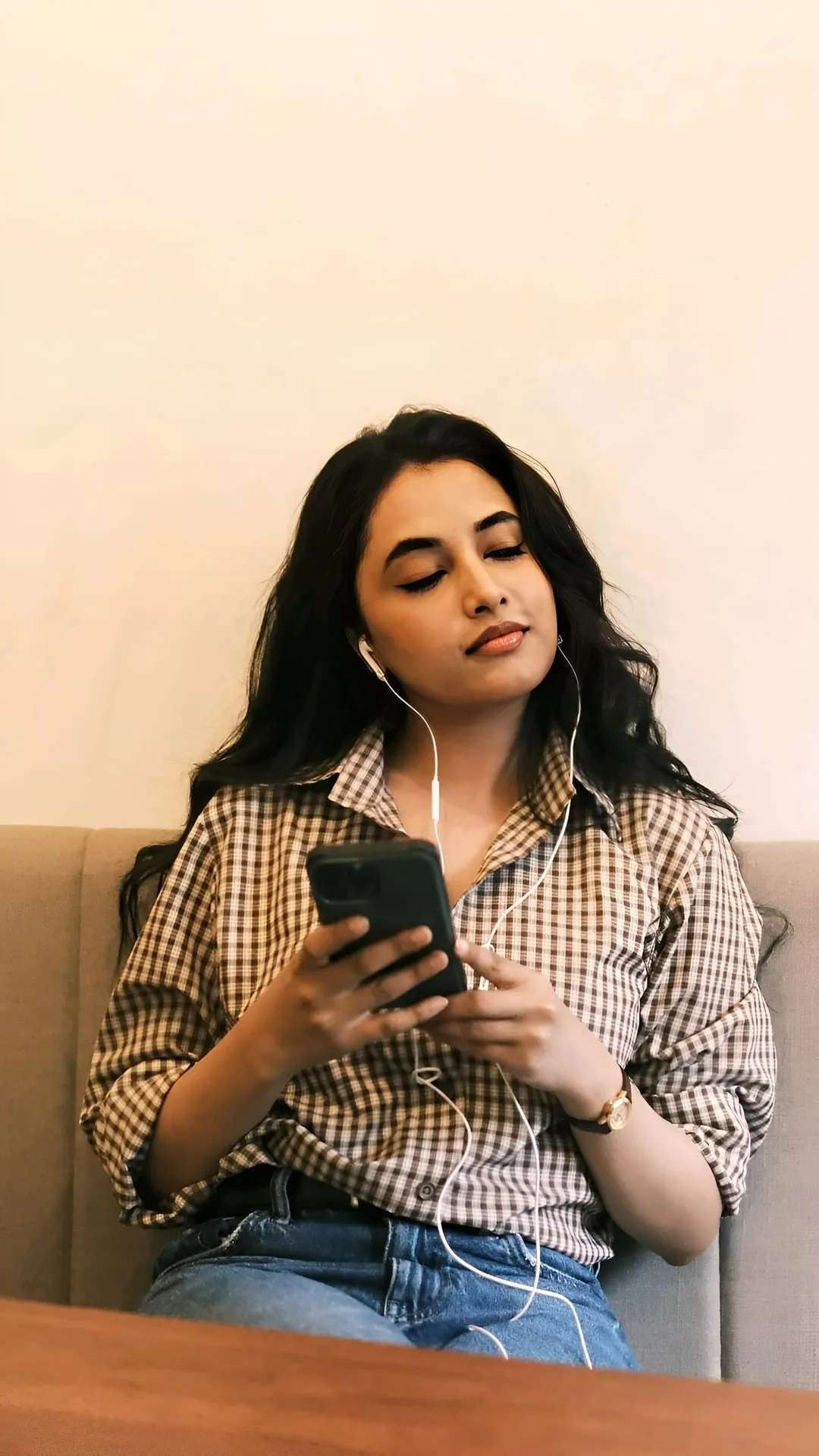 Priyanka Mohan in a Checked Shirt Holding a Mobile Phone