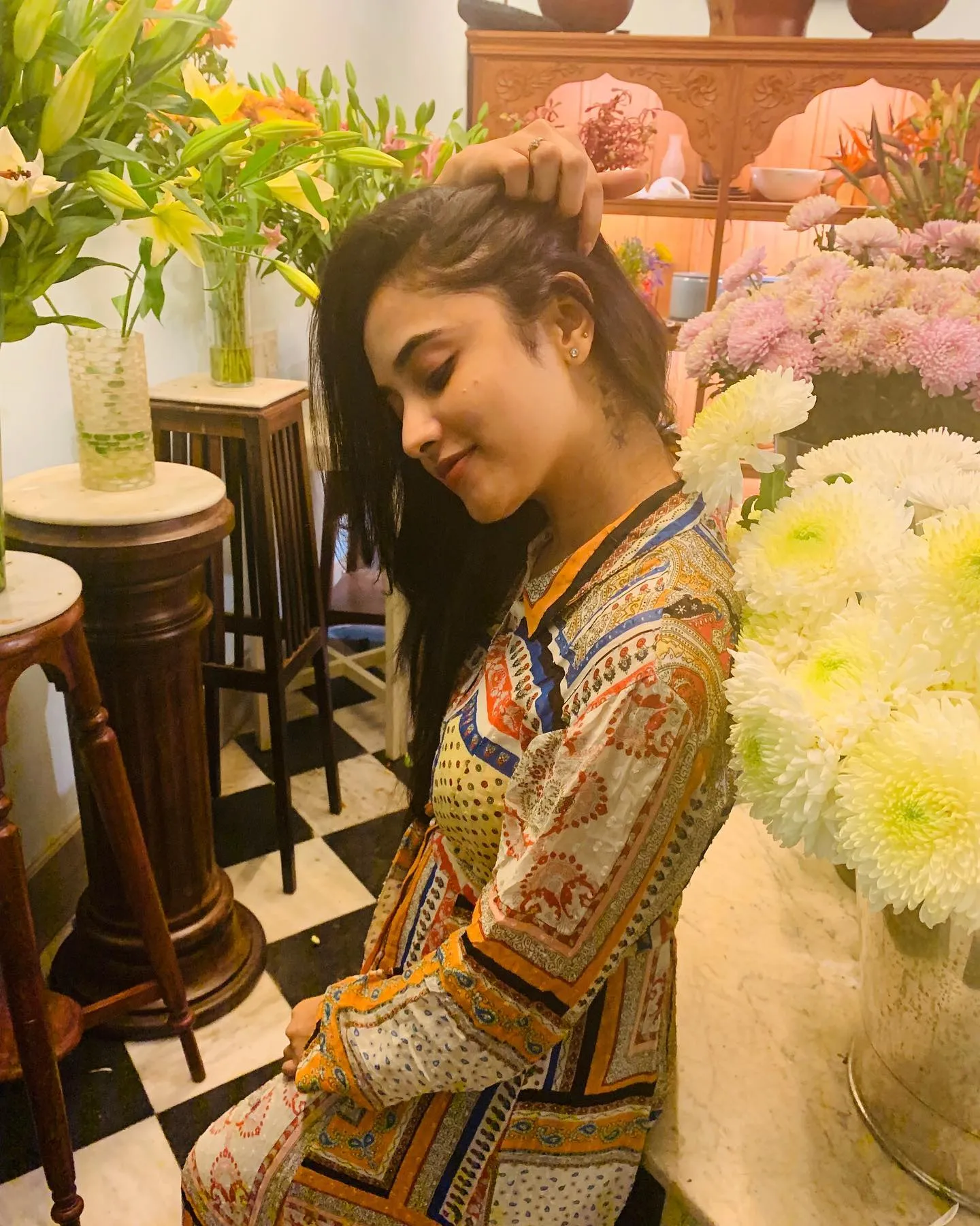 Priyanka Mohan in a Colourful Dress Standing Near Flowers