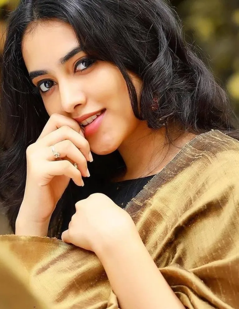 Priyanka Mohan in a Golden Saree with Biting Her Nails Pose
