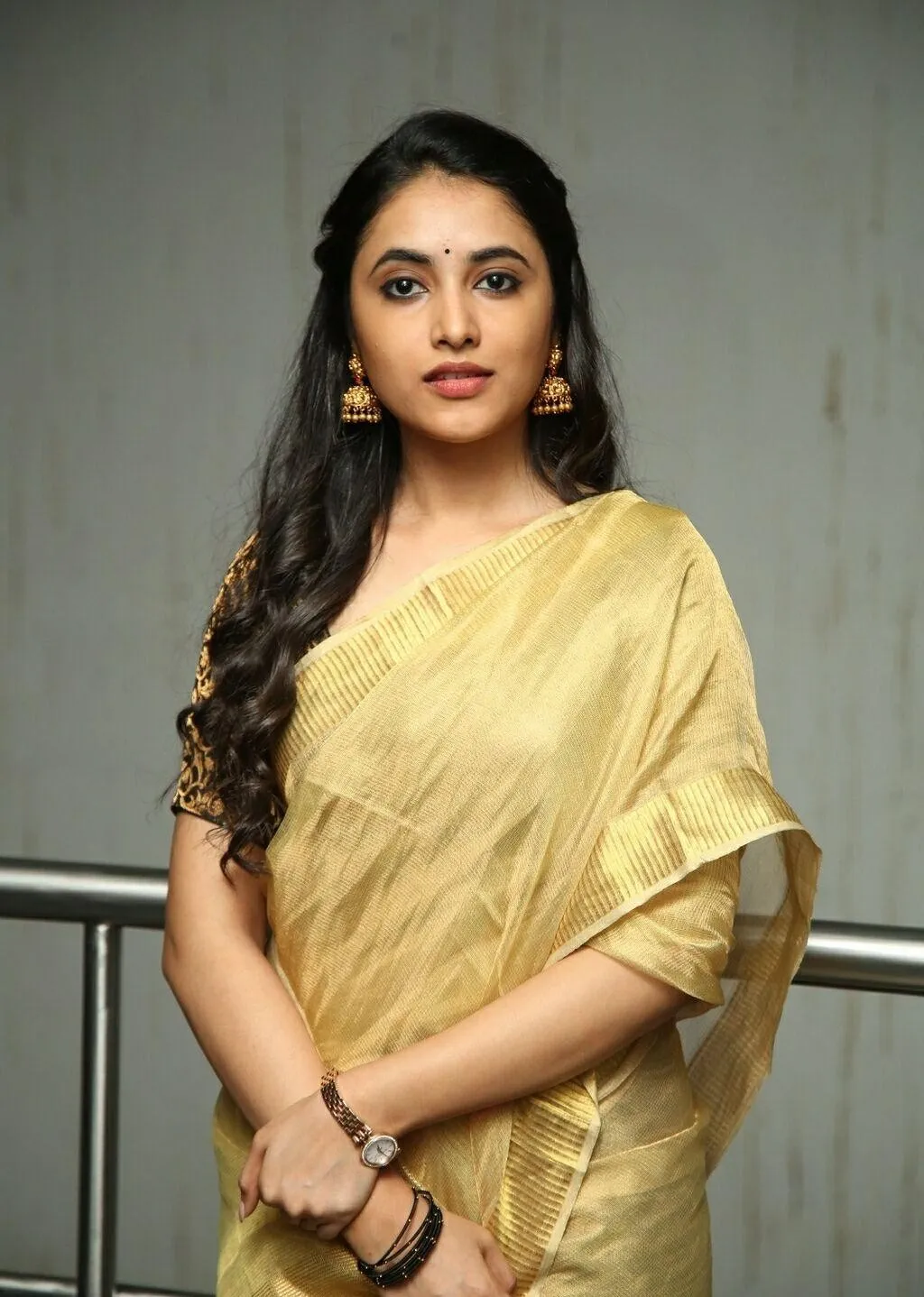 Priyanka Mohan in a Golden Saree with Hand Holding Pose