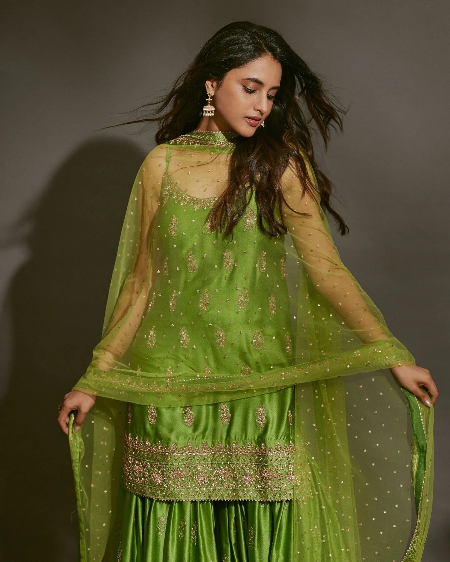 Priyanka Mohan in a Green Sharara Set Standing in the Studio
