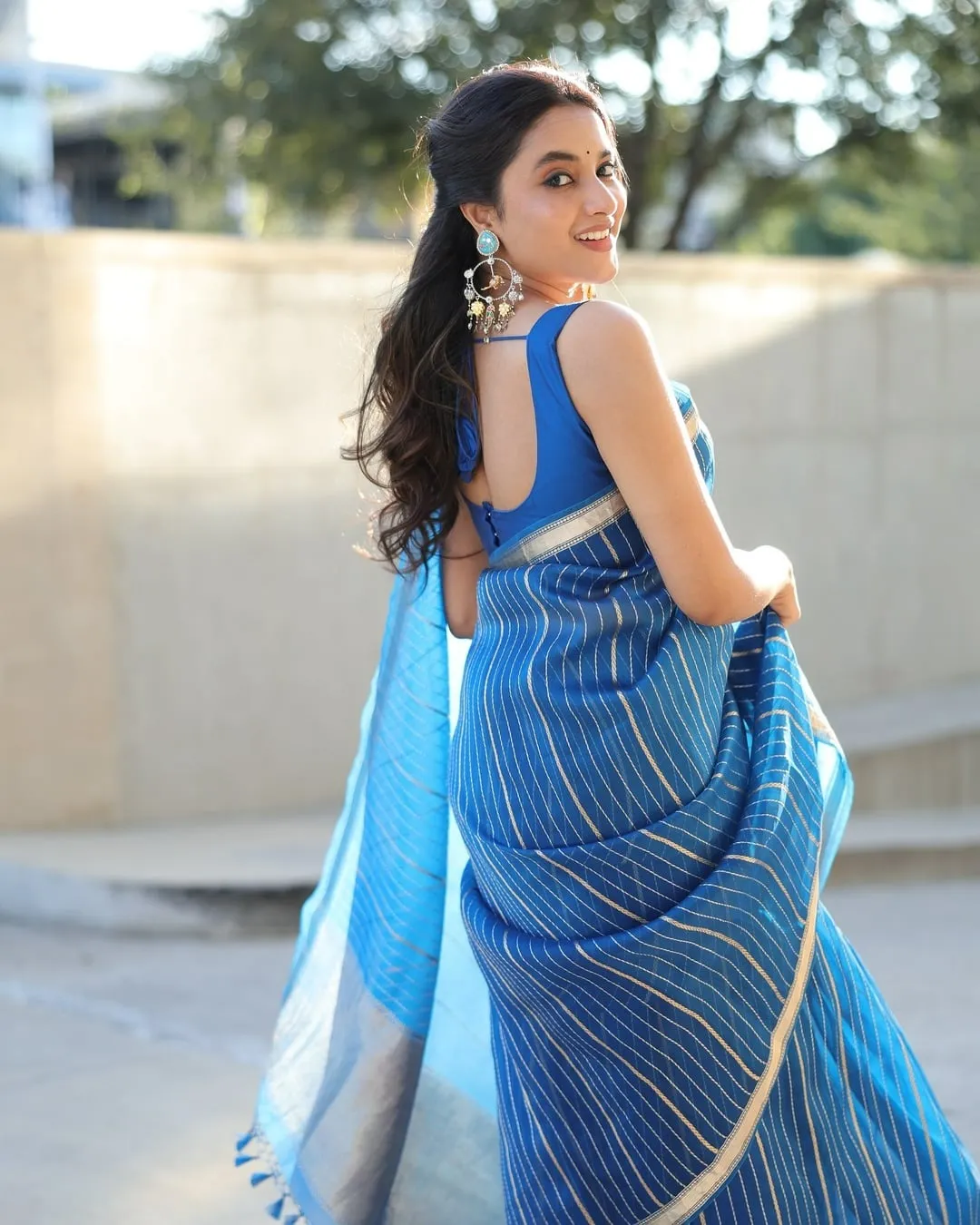 Priyanka Mohan in a Looking Back Pose Wearing a Blue Saree