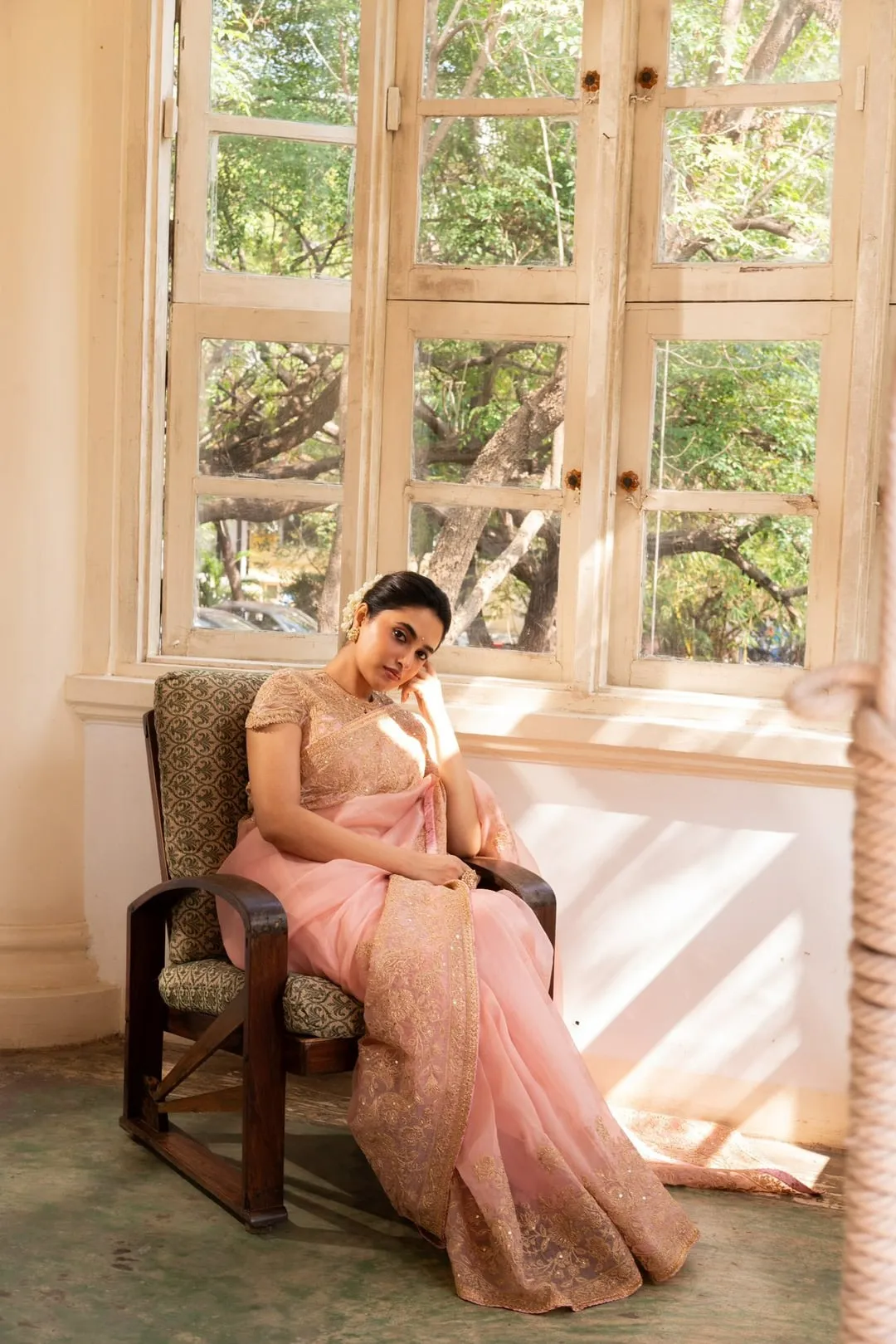 Priyanka Mohan in a Pink Saree Sitting Near the Window