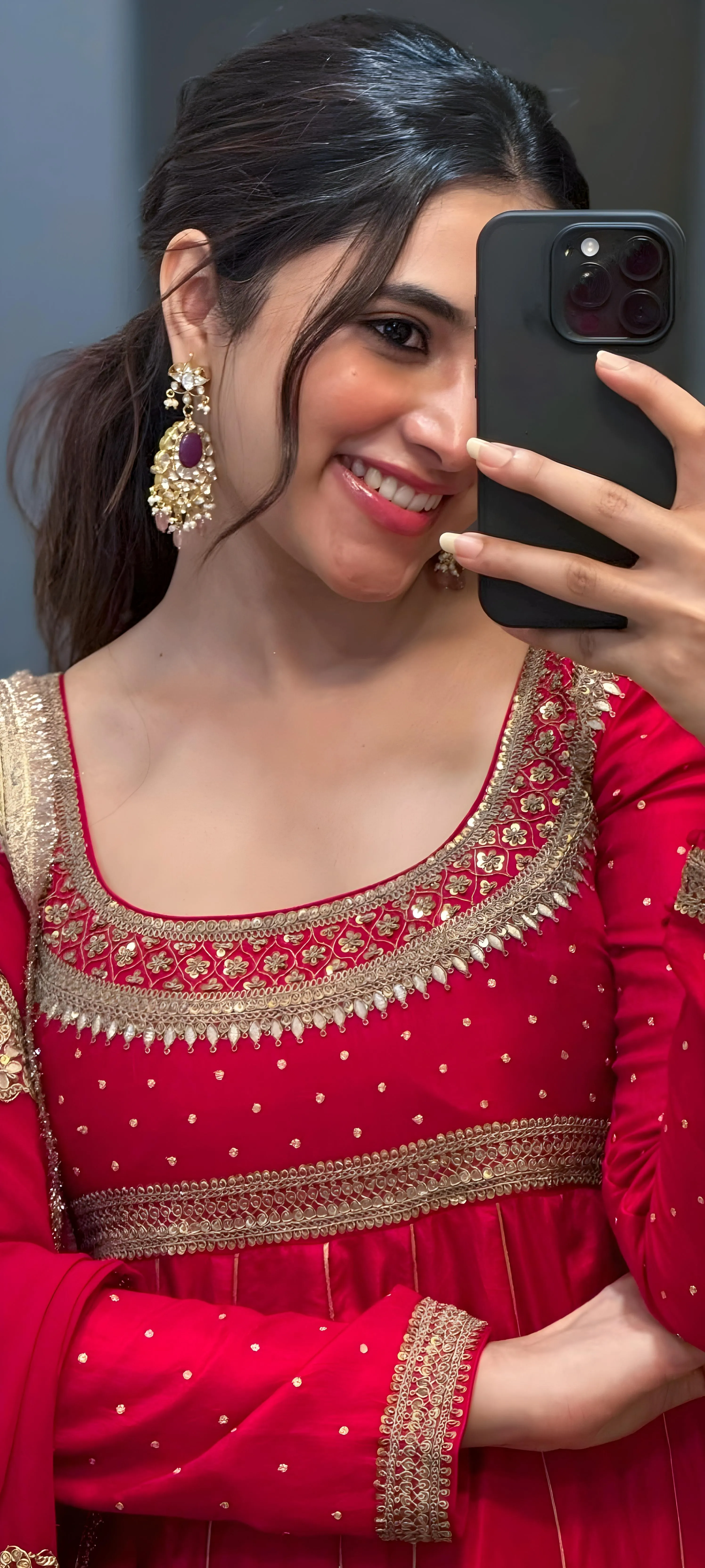Priyanka Mohan in a Red Anarkali Holding an Iphone Wallpaper