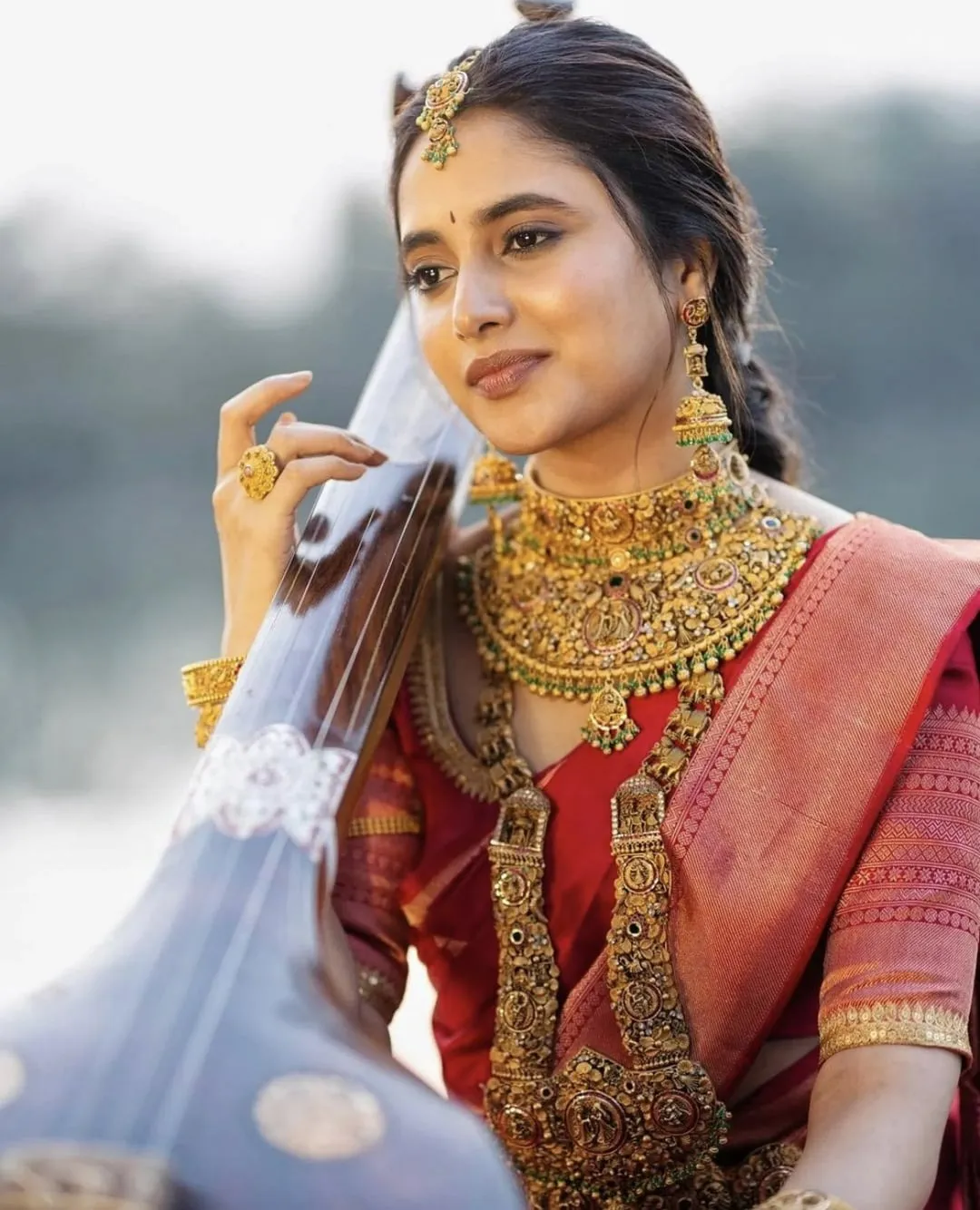 Priyanka Mohan in a Red Saree Playing Veena Free Wallpaper
