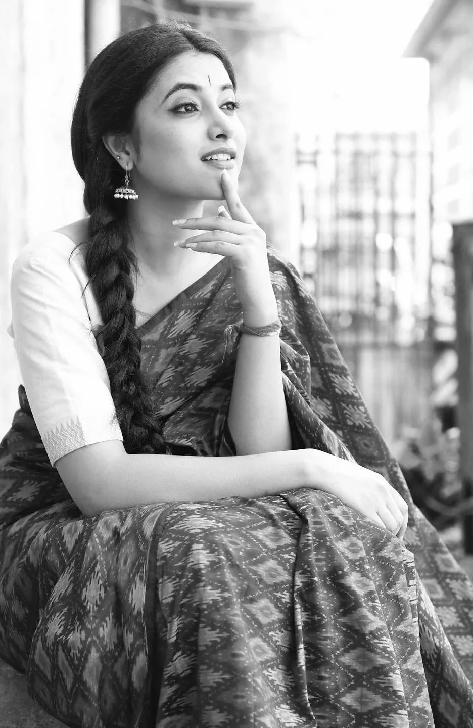 Priyanka Mohan in a Saree Sitting with Thoughtful Pose Image