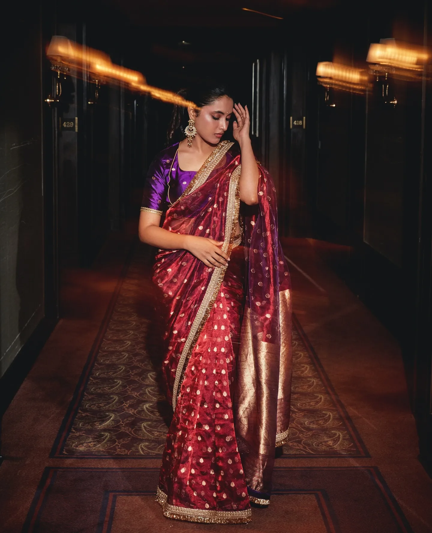 Priyanka Mohan in a Shining Red Saree with Her Hand on Head
