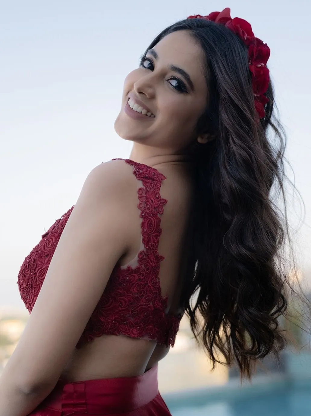 Priyanka Mohan in a Side Pose Wearing a Red Dress Wallpaper