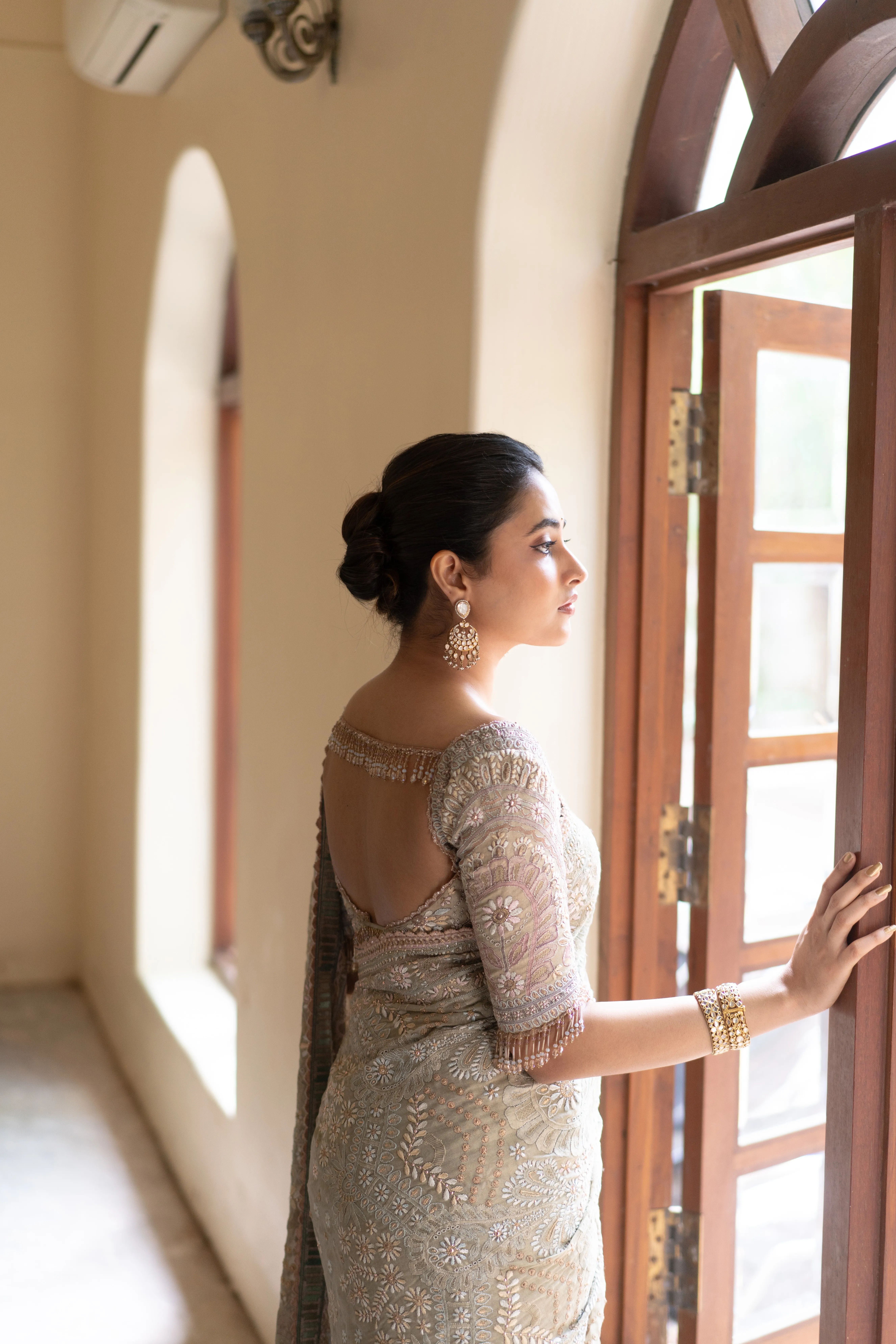 Priyanka Mohan in a Silver Saree Standing Near the Door