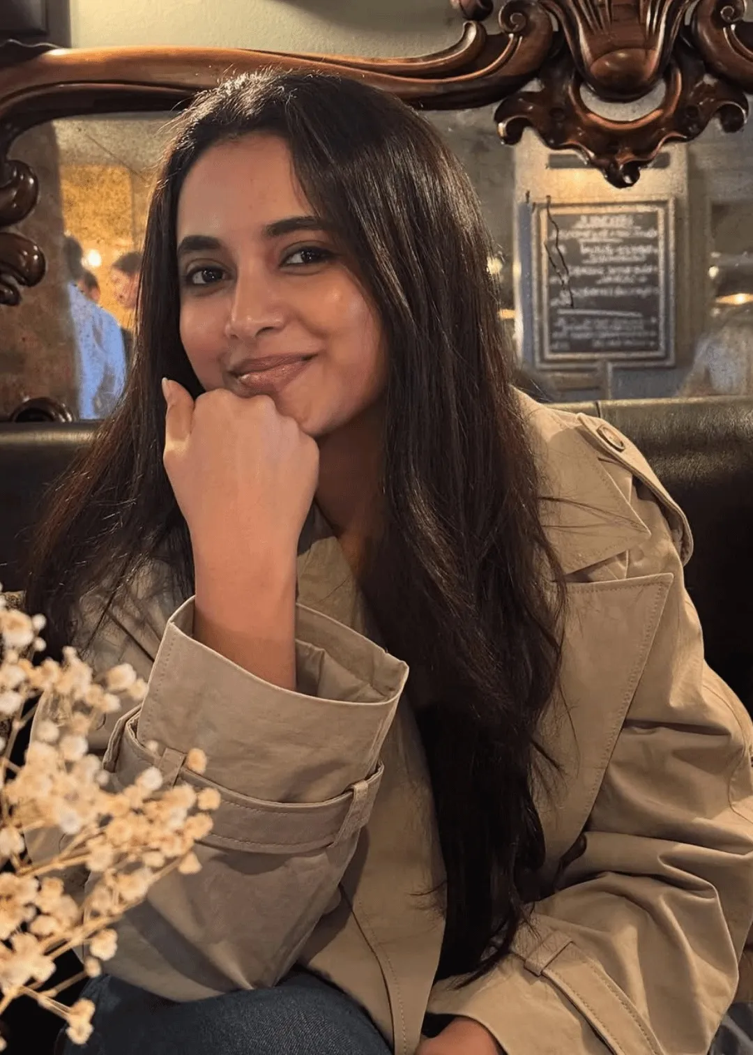 Priyanka Mohan in a Trench Coat with Her Hand on Her Cheek