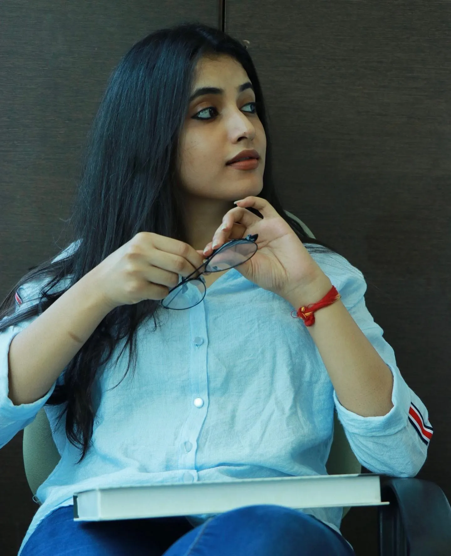 Priyanka Mohan in a White Dress Holding a Glasses And a Book